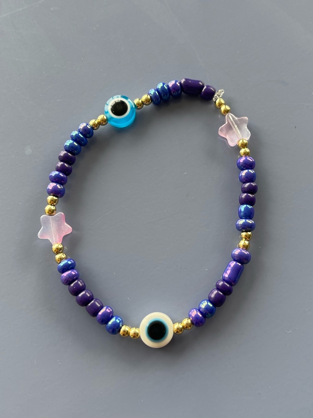 Purple Beaded Bracelet with Pink Star Charms and Blue Evil Eye